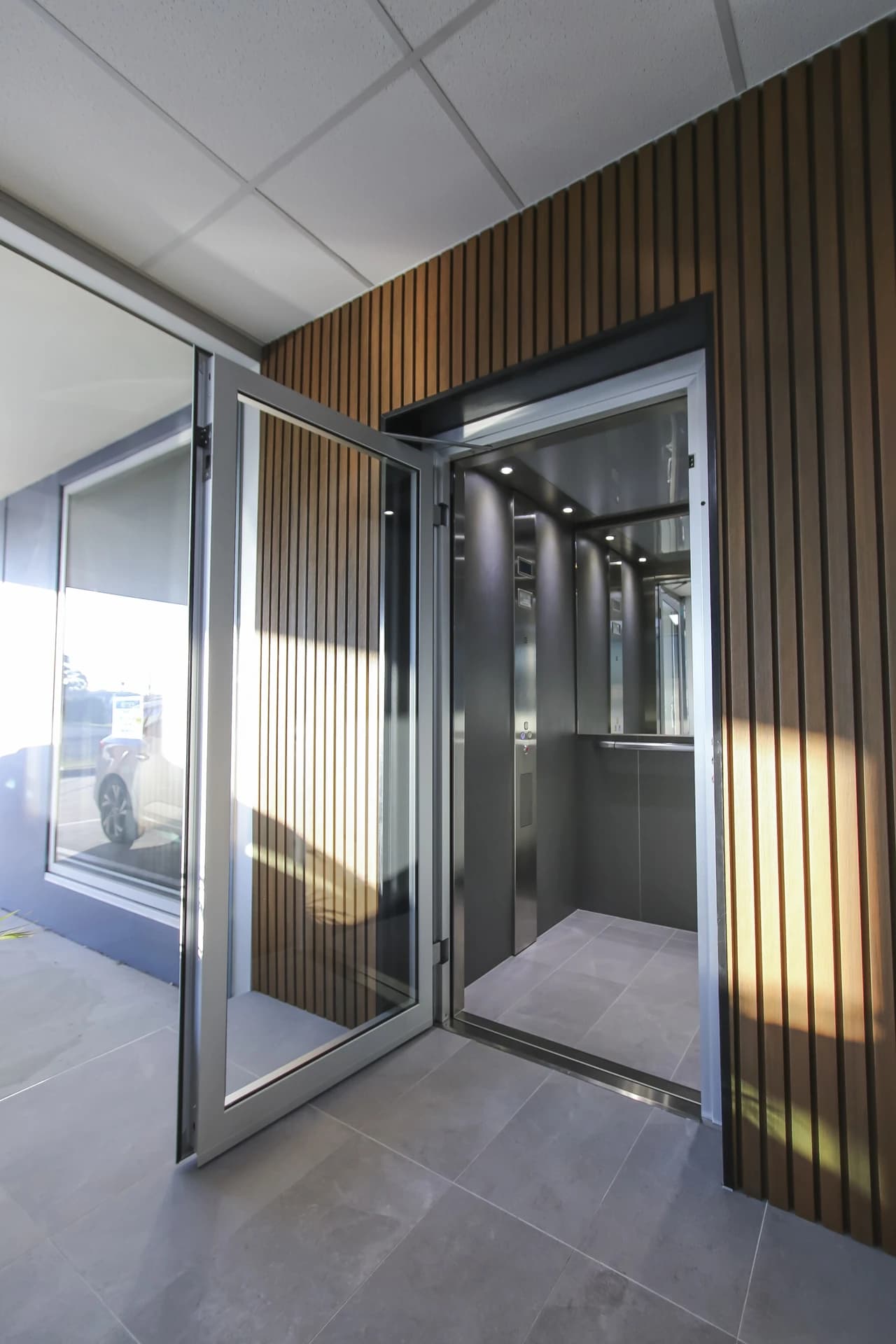 Home lift with swing door