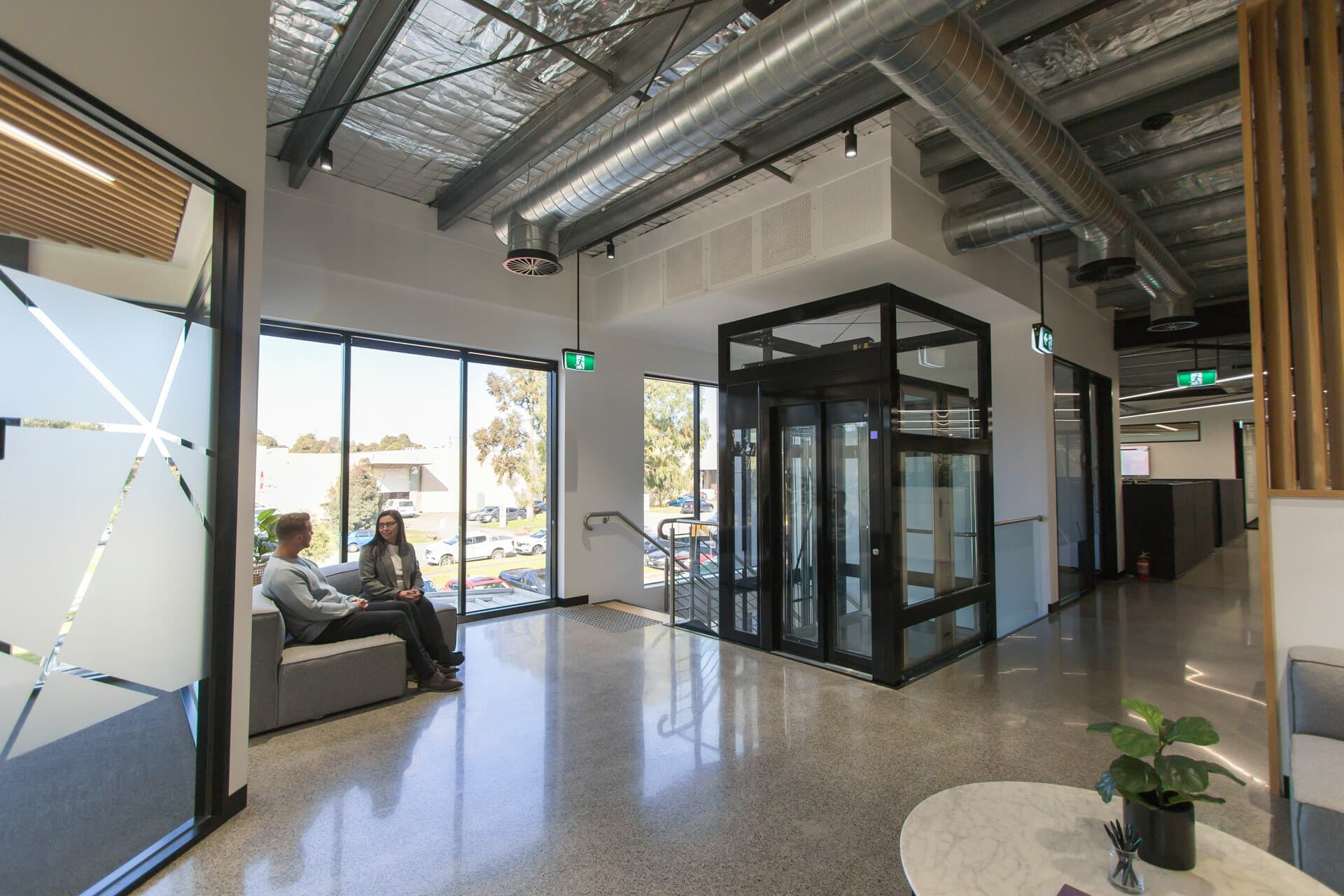 A Southern Lifts glass lift installed and operating in a Melbourne office fitout